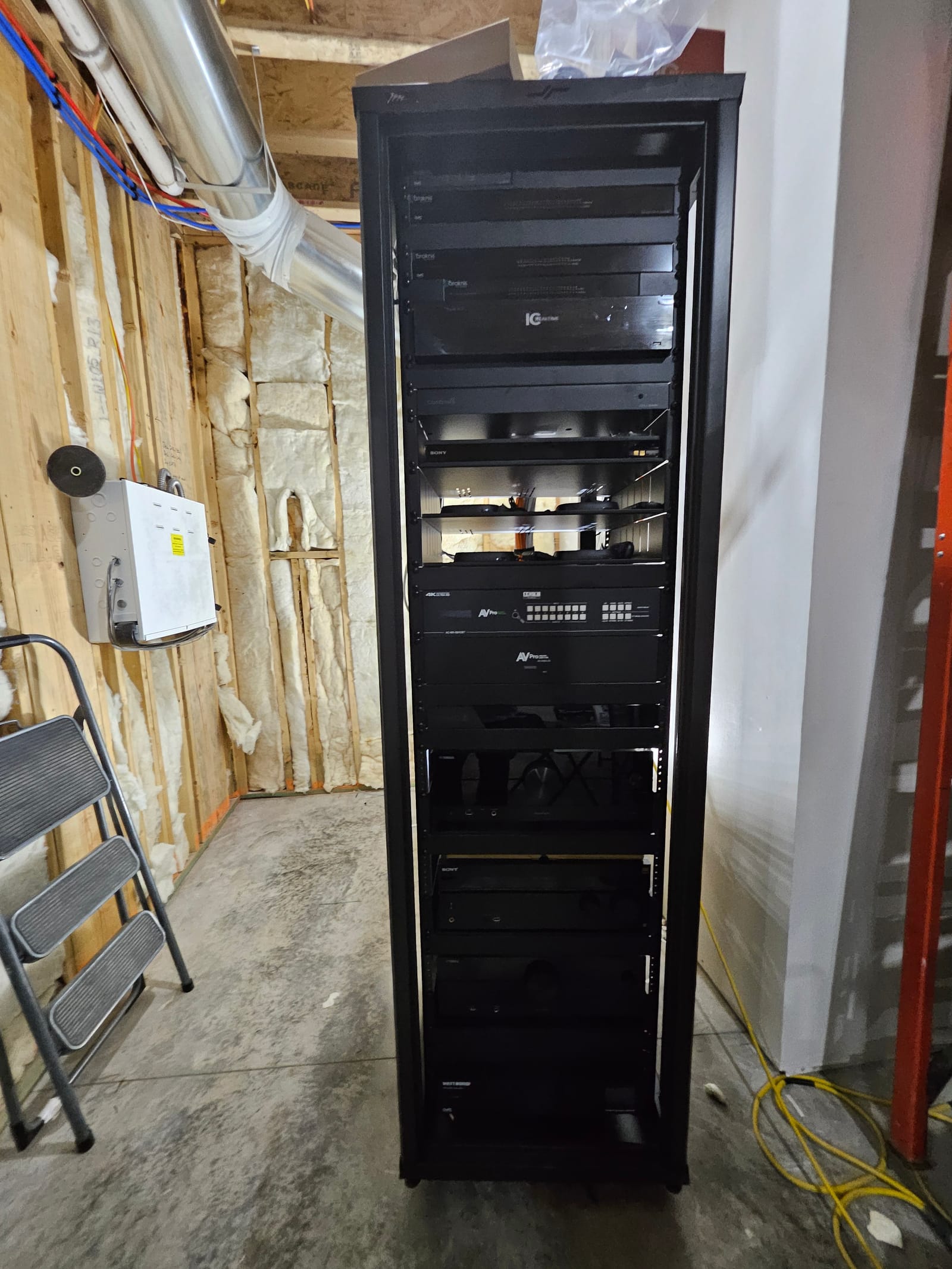 Large floor-mounted equipment rack installed in a mechanical room, Noble A-V commercial rack build
