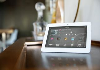 Noble Audio and Video team member configuring a Control4 smart home system on a tablet