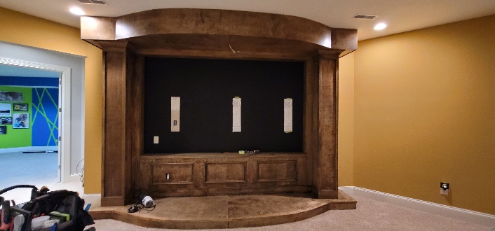 Custom theater with acoustic-transparent projection screen by Noble A-V