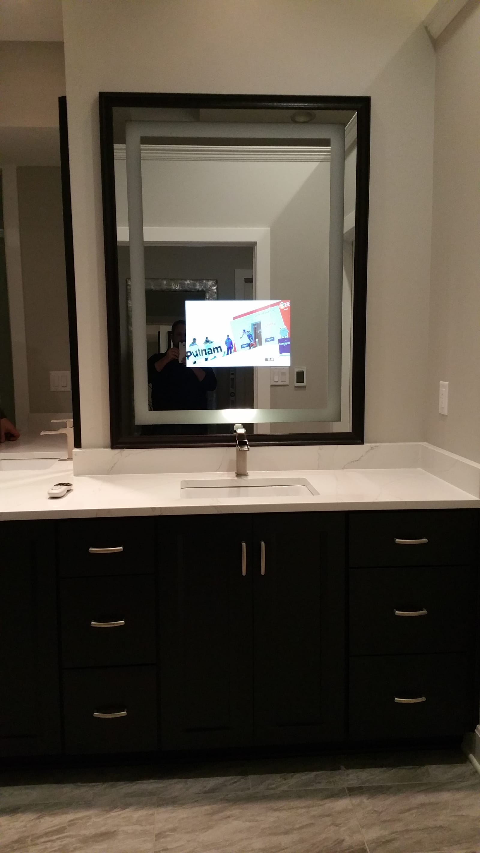 Séura mirror television integrated into a luxury bathroom, appears as a mirror when off